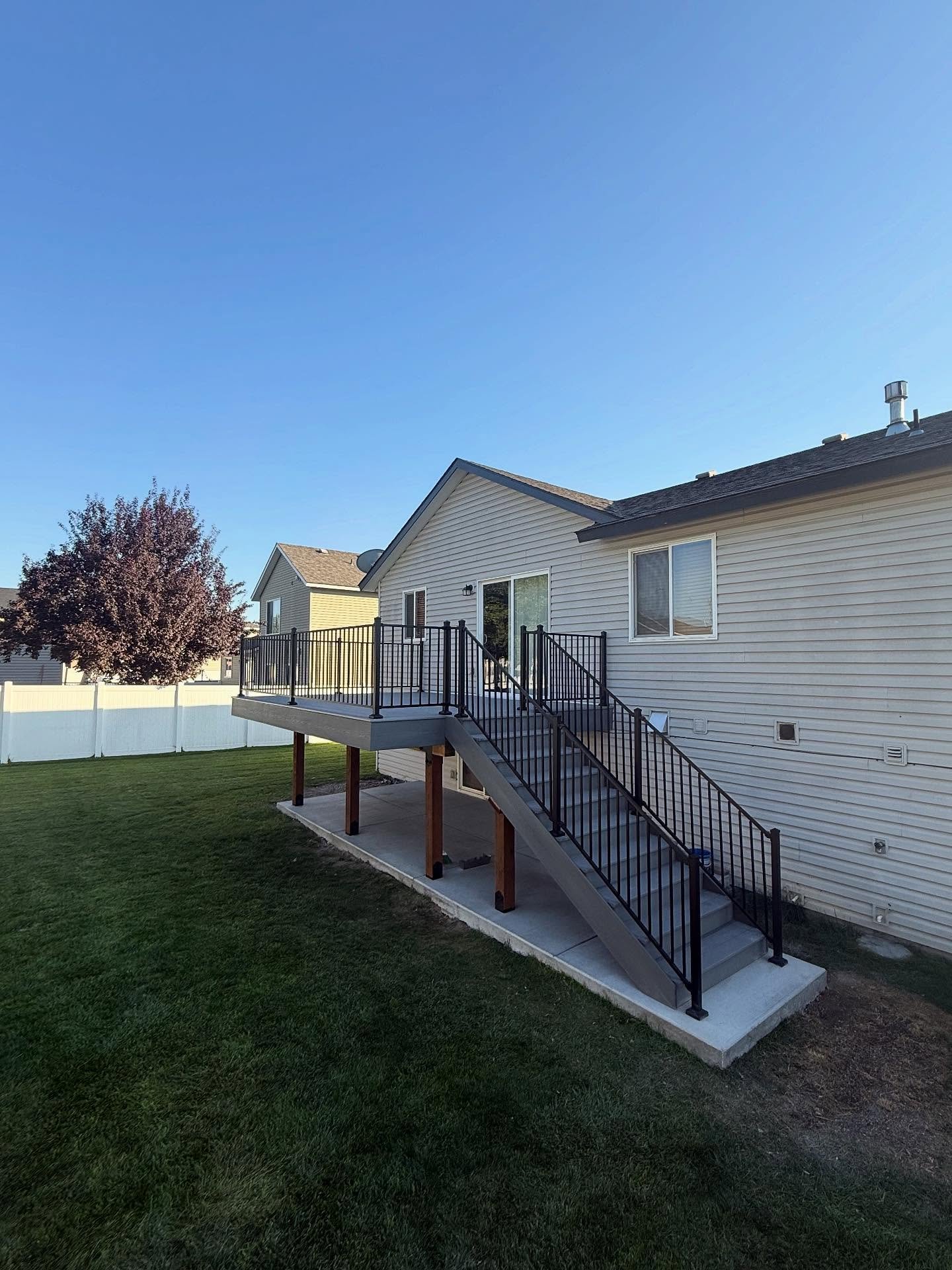 Rebuilt deck with fresh railings and stained boards